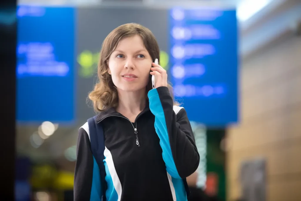 woman calling on the phone to make a flight claim